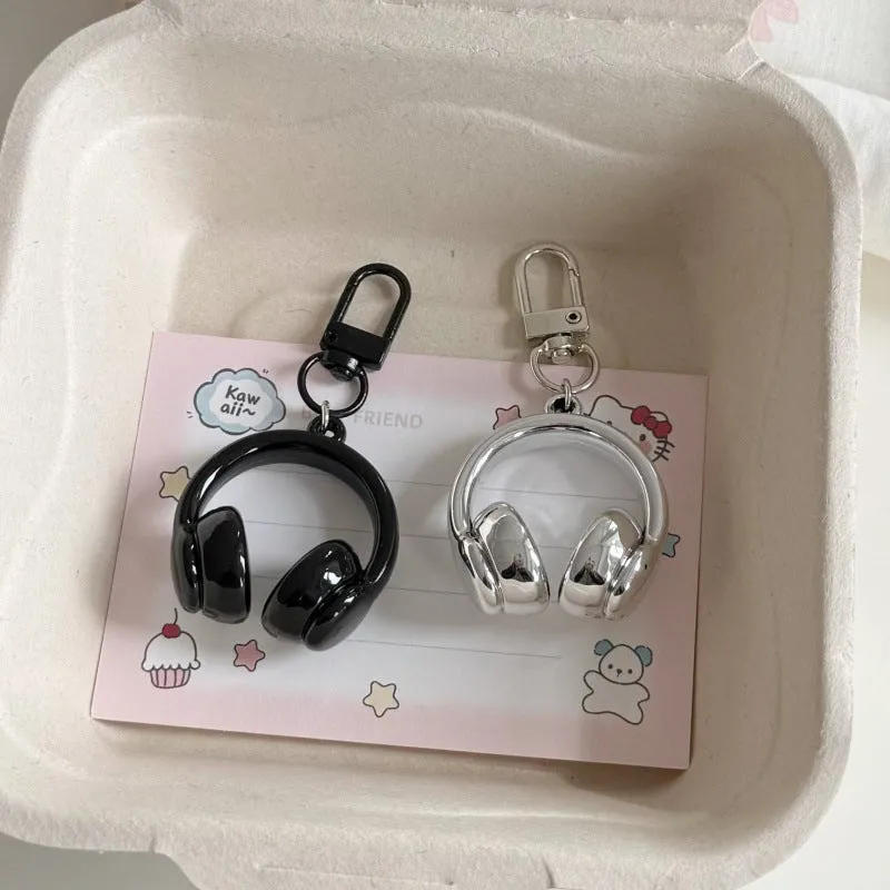 Small earphone pendant keychain with baking varnish finish in black on grey background