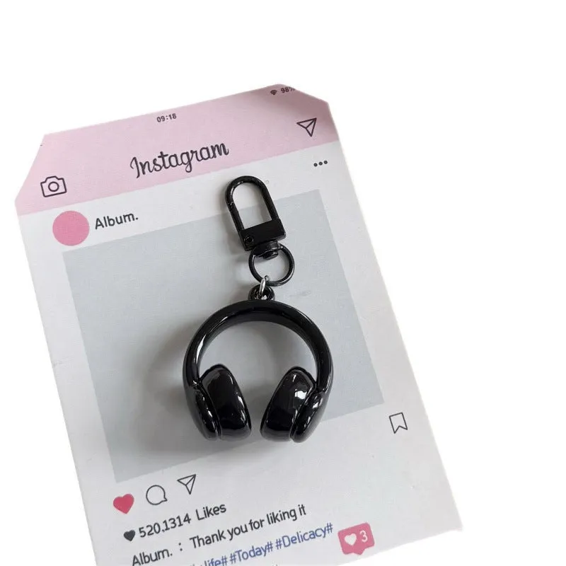 Small earphone pendant keychain with baking varnish finish in black on grey background
