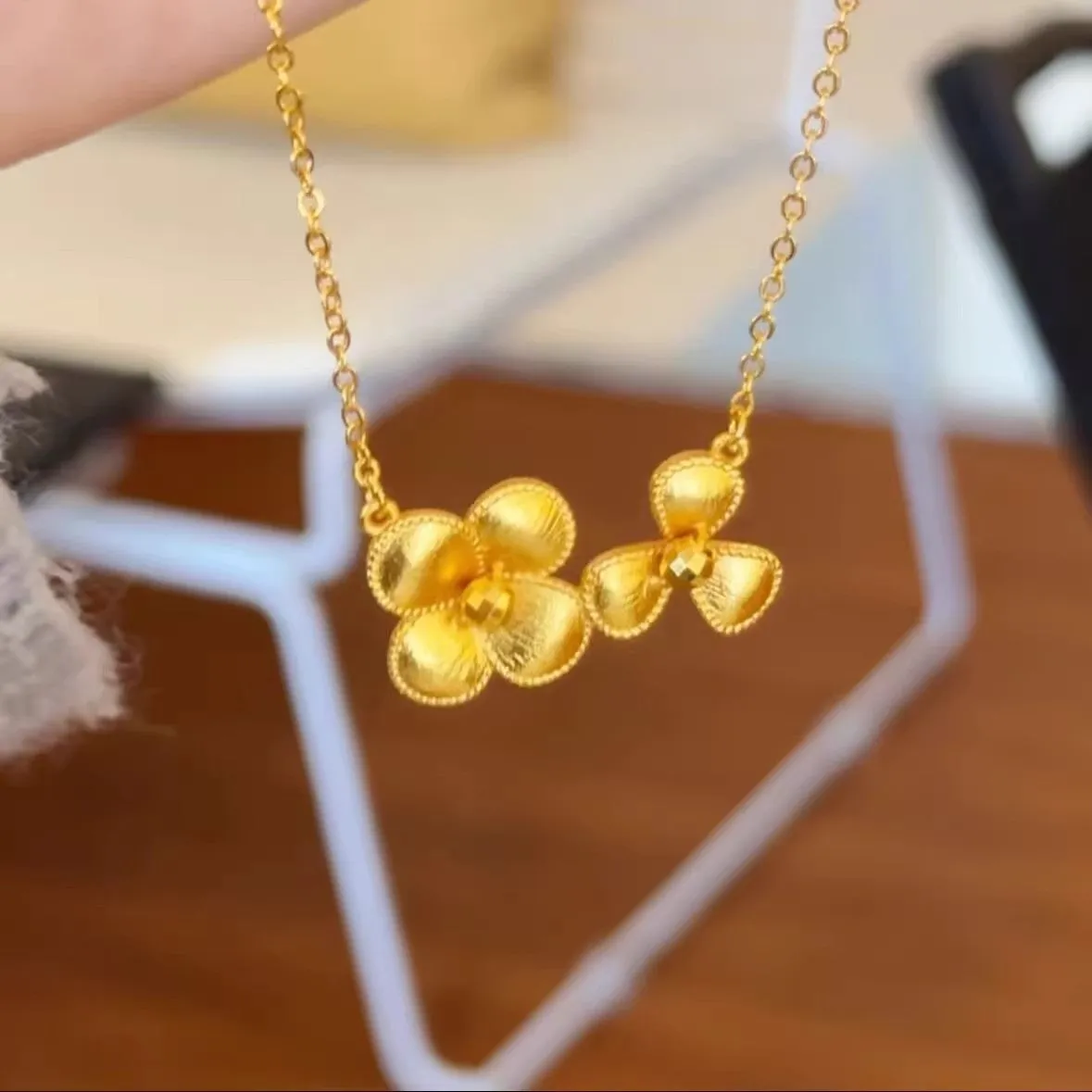 Gold plated brass flower necklace with bright floral pendant on adjustable clavicle chain