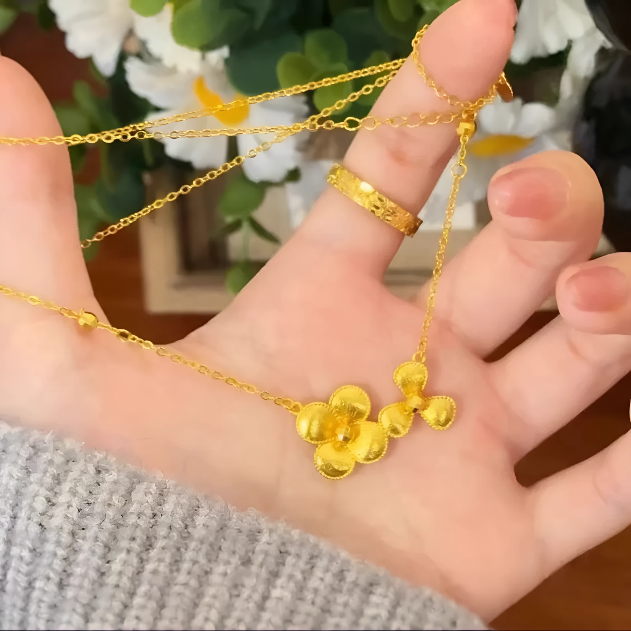 Gold plated brass flower necklace with bright floral pendant on adjustable clavicle chain