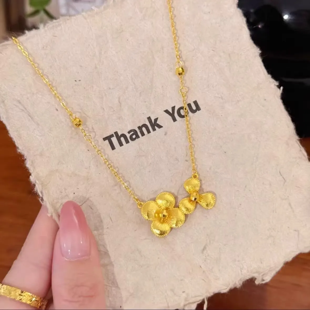 Gold plated brass flower necklace with bright floral pendant on adjustable clavicle chain