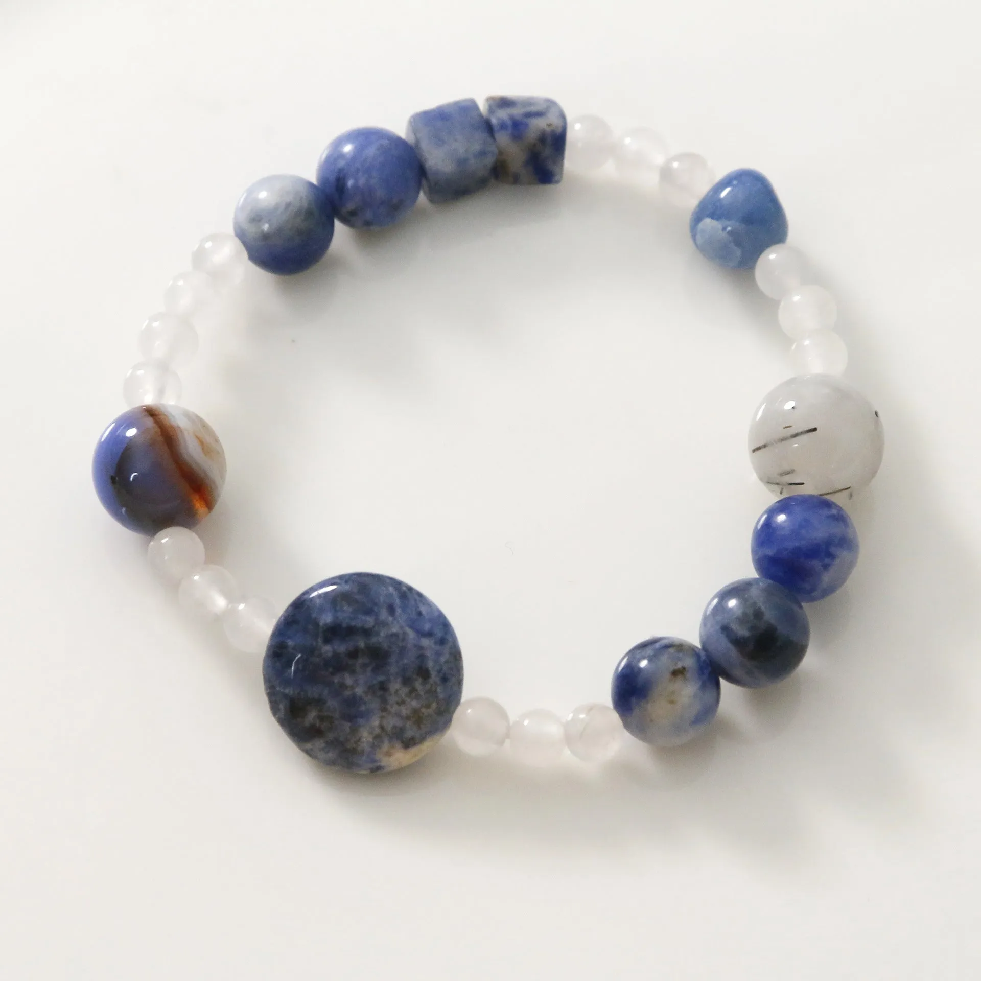 Hand-woven natural blue point stone and black hair crystal agate bracelet with geometric design