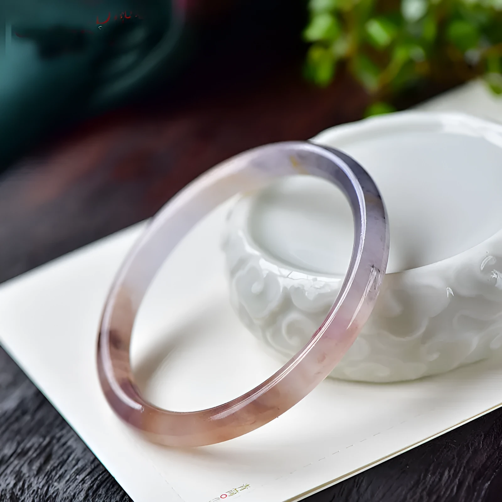 Violet jade bracelet with polished beads shown in flat bar and round bar styles on a wrist.