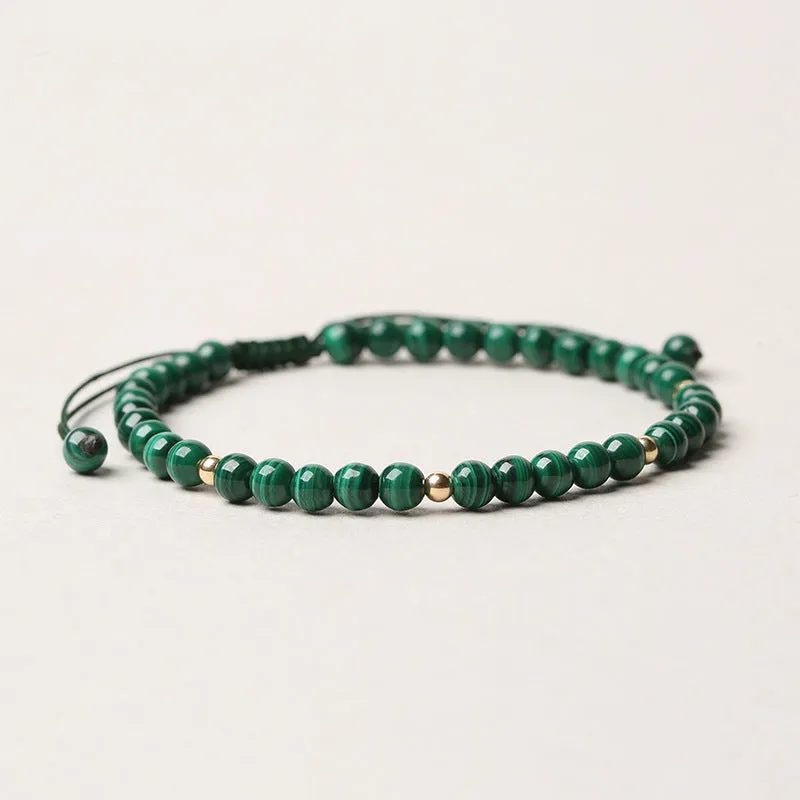 Green malachite stone bracelet with golden beads on woven strap, zodiac animal motif.