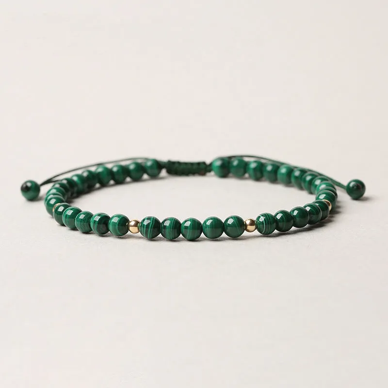 Green malachite stone bracelet with golden beads on woven strap, zodiac animal motif.