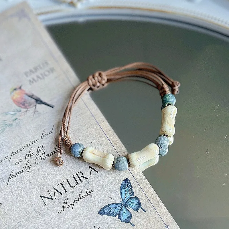 Women's ceramic braided bracelet with hand-woven cord and ceramic beads in traditional Chinese pattern