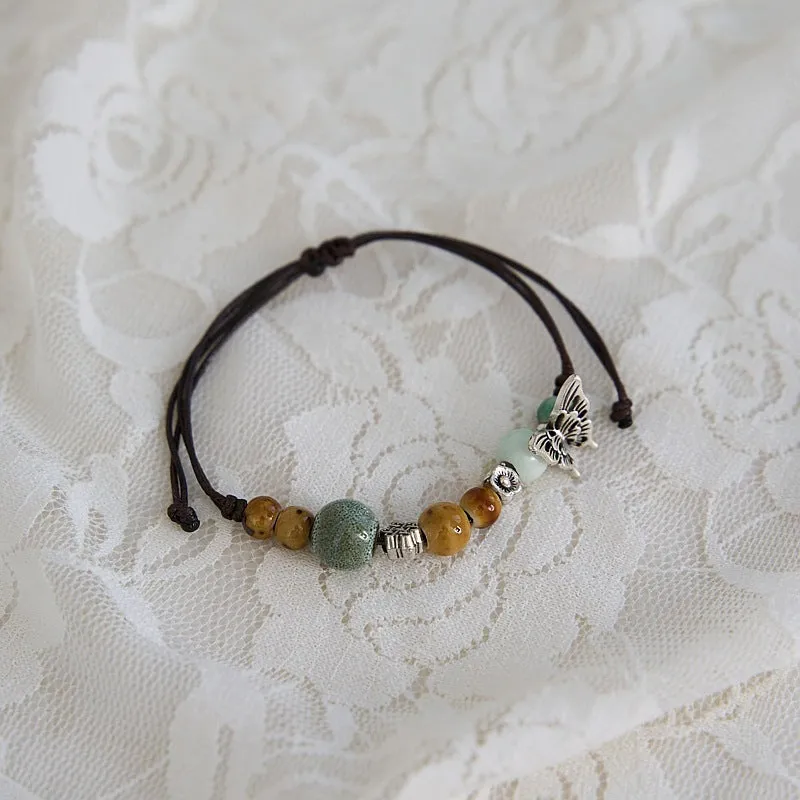 Women's ceramic braided bracelet with hand-woven cord and ceramic beads in traditional Chinese pattern