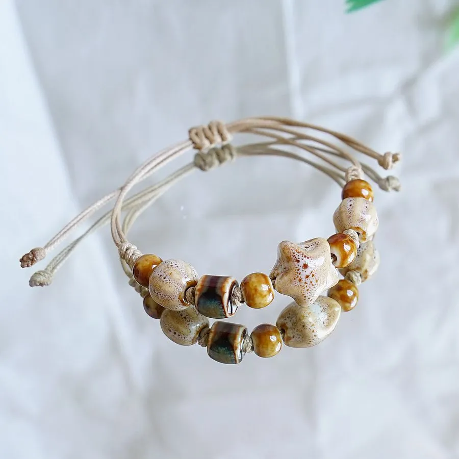 Women's ceramic braided bracelet with hand-woven cord and ceramic beads in traditional Chinese pattern
