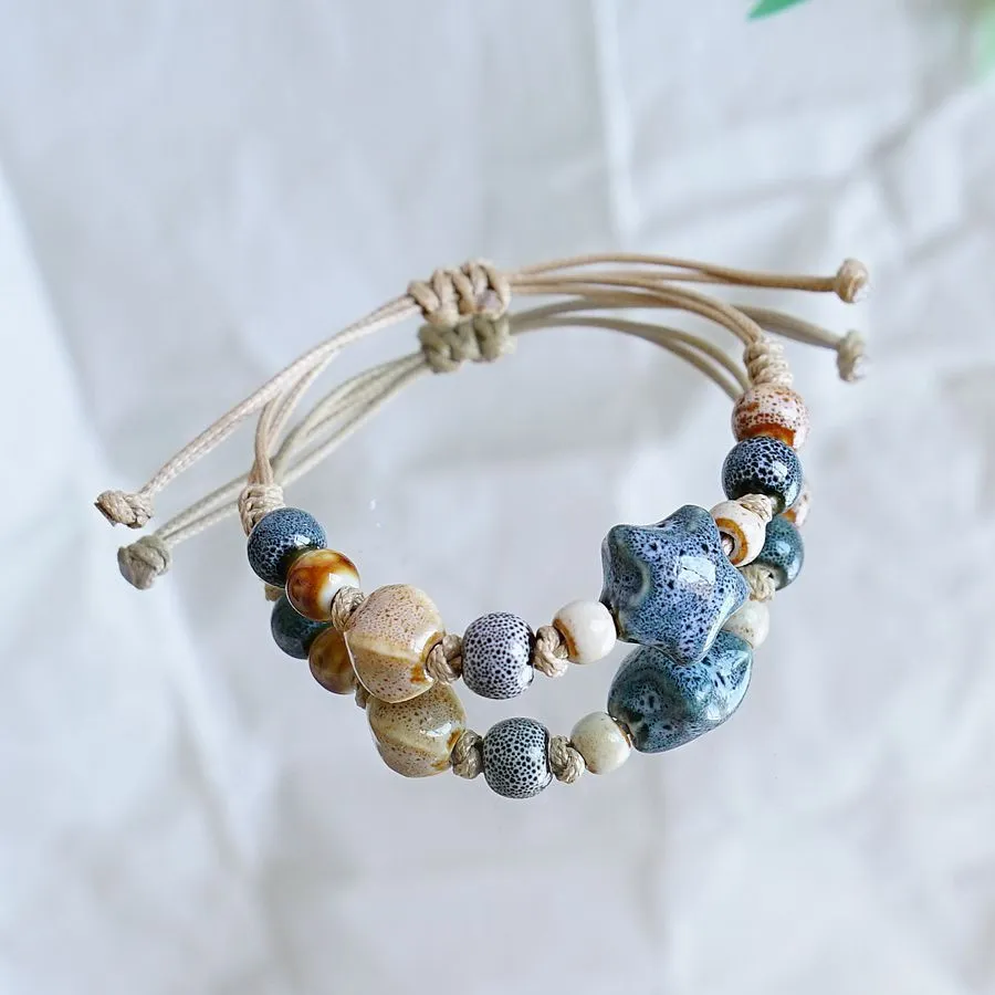 Women's ceramic braided bracelet with hand-woven cord and ceramic beads in traditional Chinese pattern