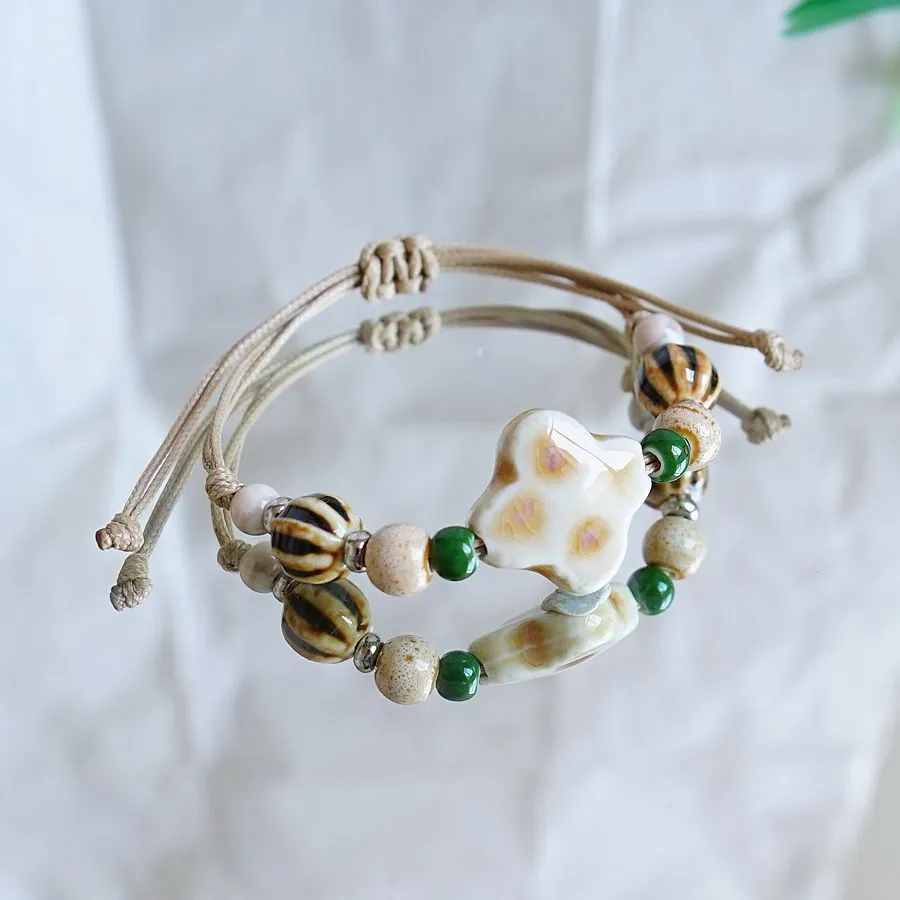 Women's ceramic braided bracelet with hand-woven cord and ceramic beads in traditional Chinese pattern