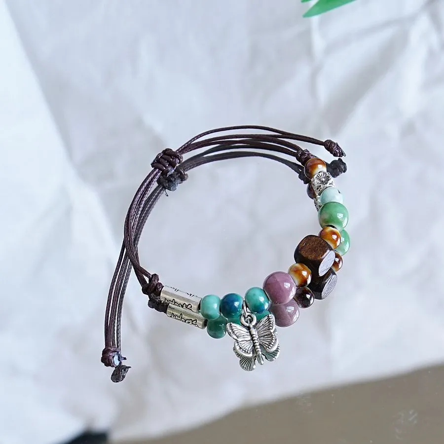 Women's ceramic braided bracelet with hand-woven cord and ceramic beads in traditional Chinese pattern