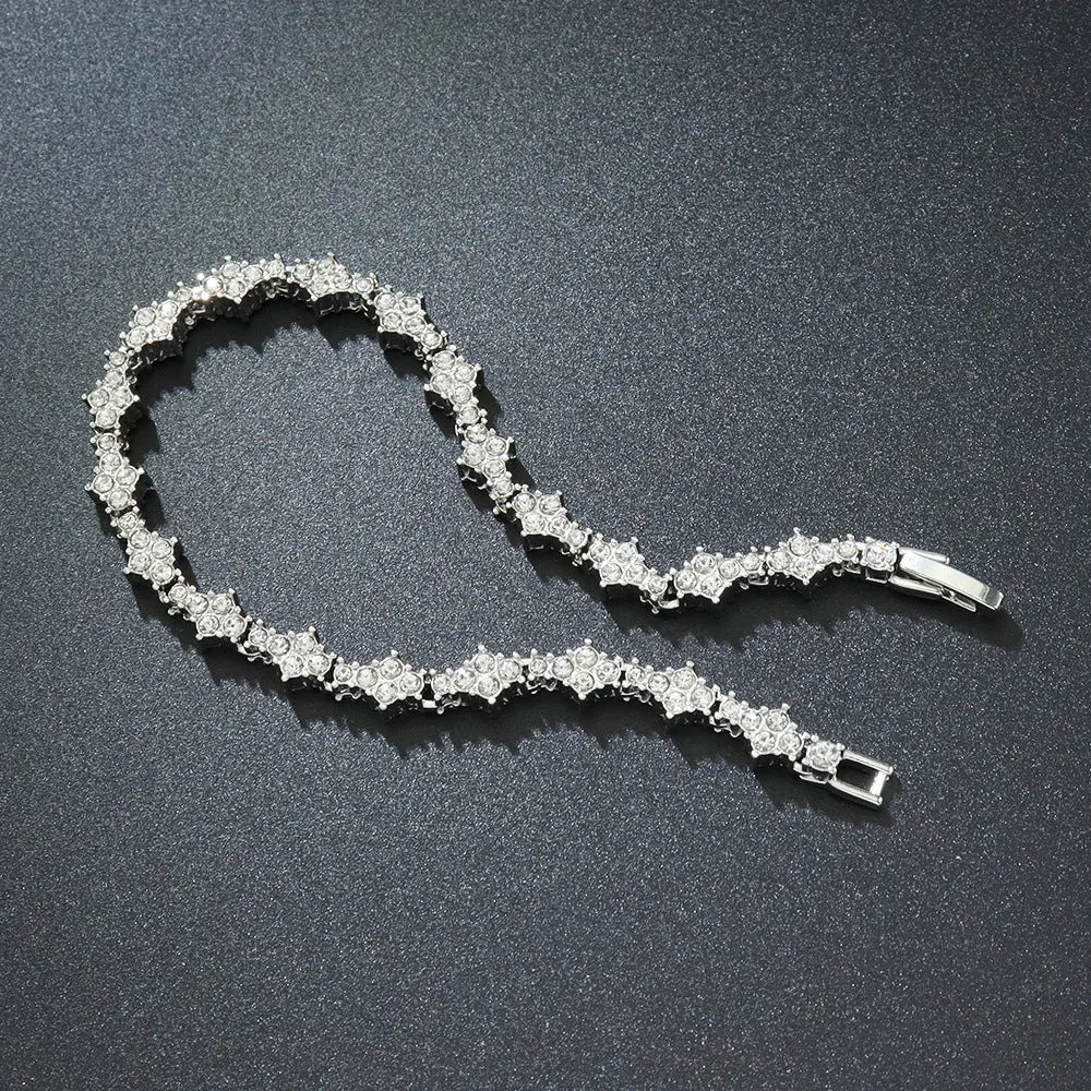 Flower-shaped cross tennis chain bracelet in gold alloy with diamond geometry pattern close-up