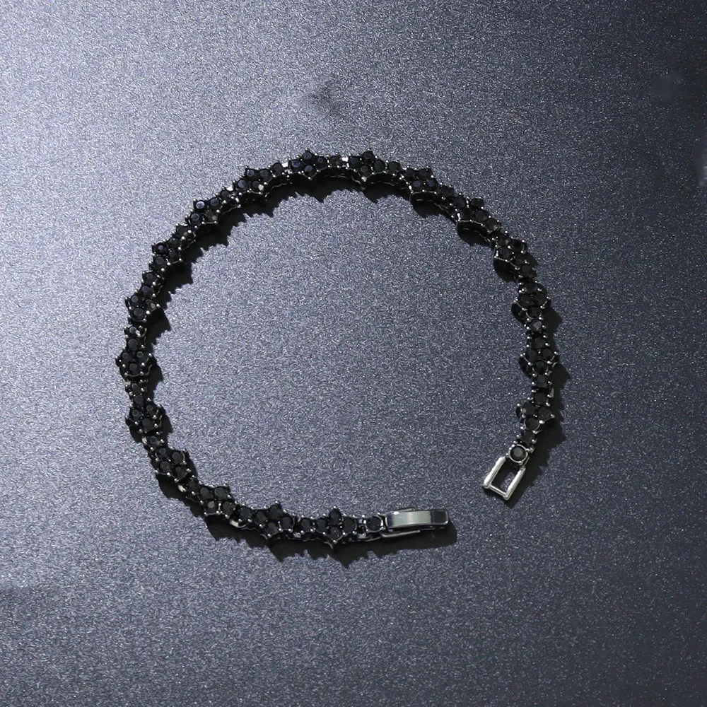 Flower-shaped cross tennis chain bracelet in gold alloy with diamond geometry pattern close-up