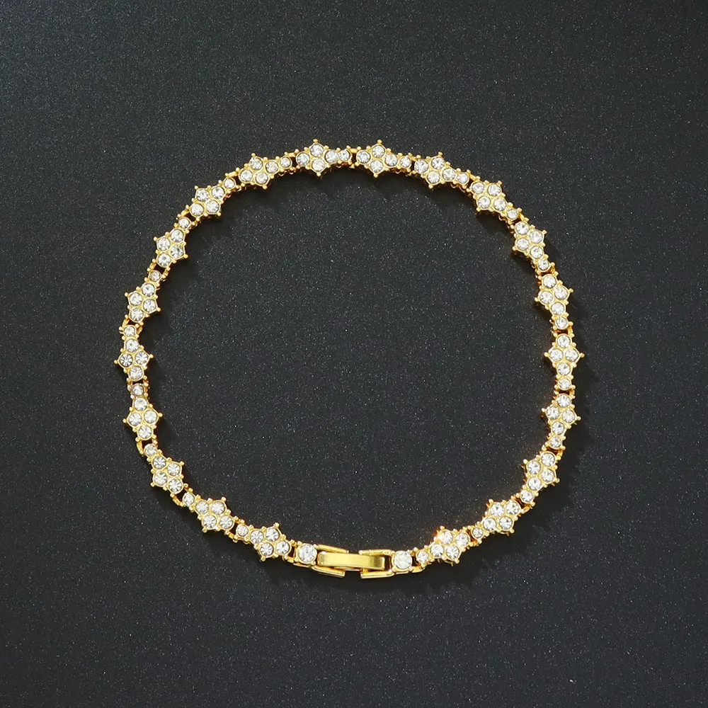 Flower-shaped cross tennis chain bracelet in gold alloy with diamond geometry pattern close-up