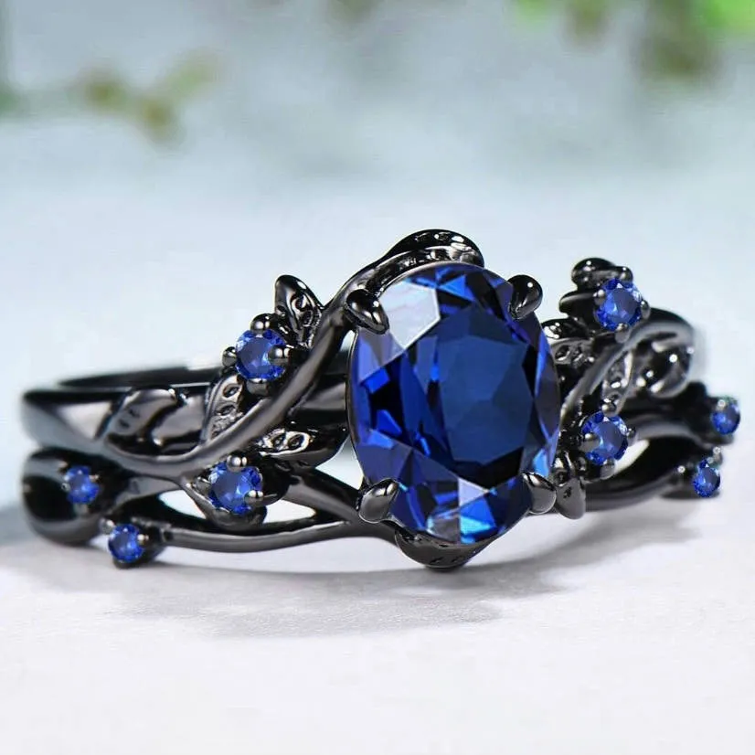 Gun black geometric copper women's ring with an inlaid navy blue rhinestone, shown in size 10.