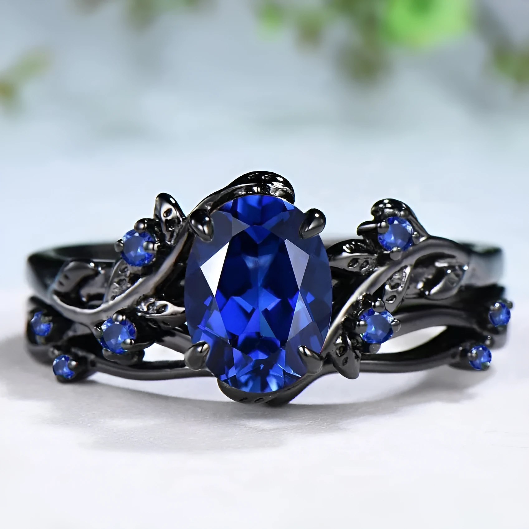 Gun black geometric copper women's ring with an inlaid navy blue rhinestone, shown in size 10.