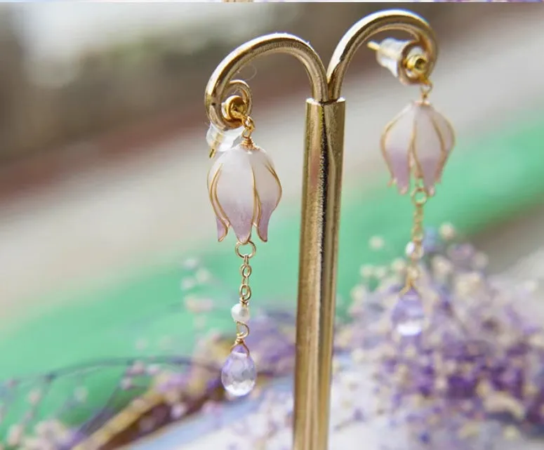 Silver plated gradient colour amethyst water drop tassel ear studs with flower core pattern on white background
