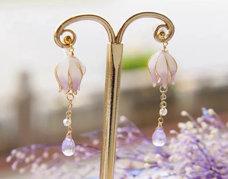 Silver plated gradient colour amethyst water drop tassel ear studs with flower core pattern on white background