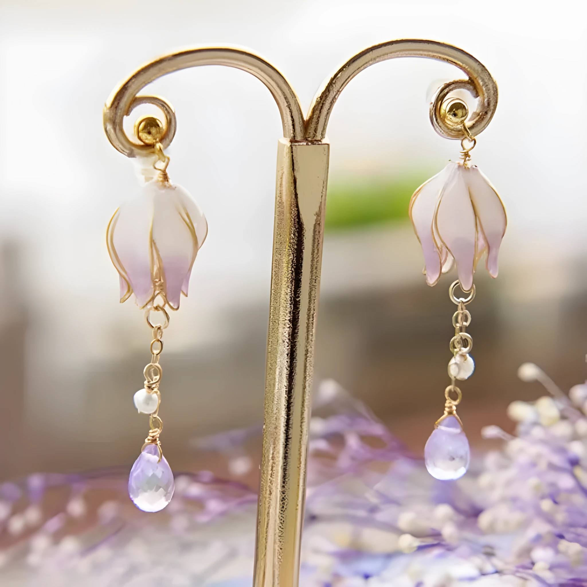 Silver plated gradient colour amethyst water drop tassel ear studs with flower core pattern on white background