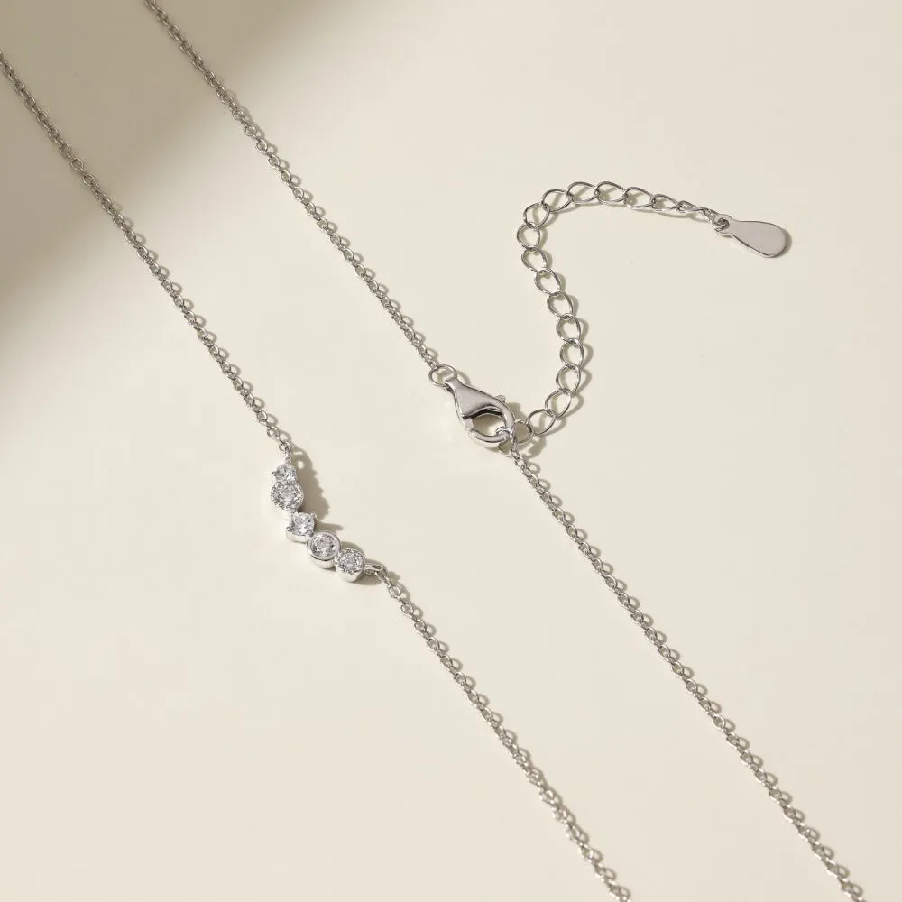 Geometric zircon pendant necklace in 925 silver with gold electroplate finish on display