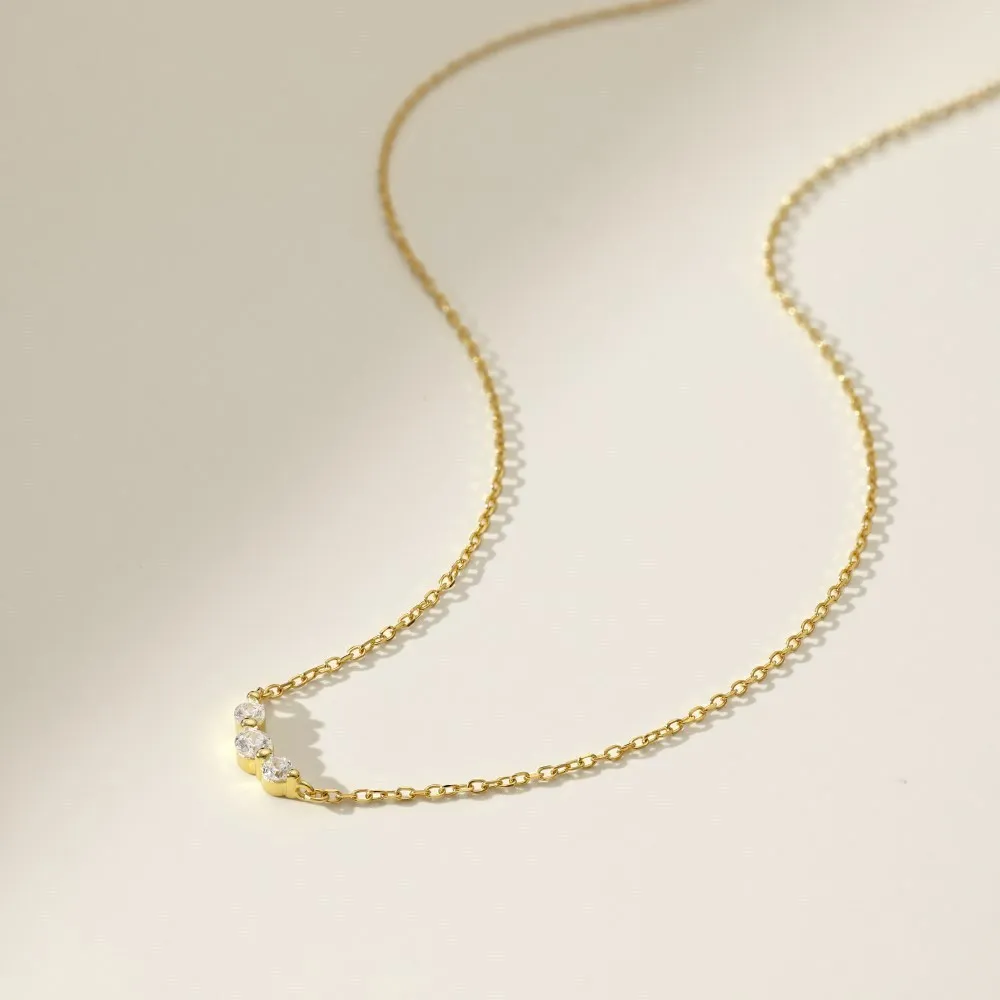 Geometric zircon pendant necklace in 925 silver with gold electroplate finish on display