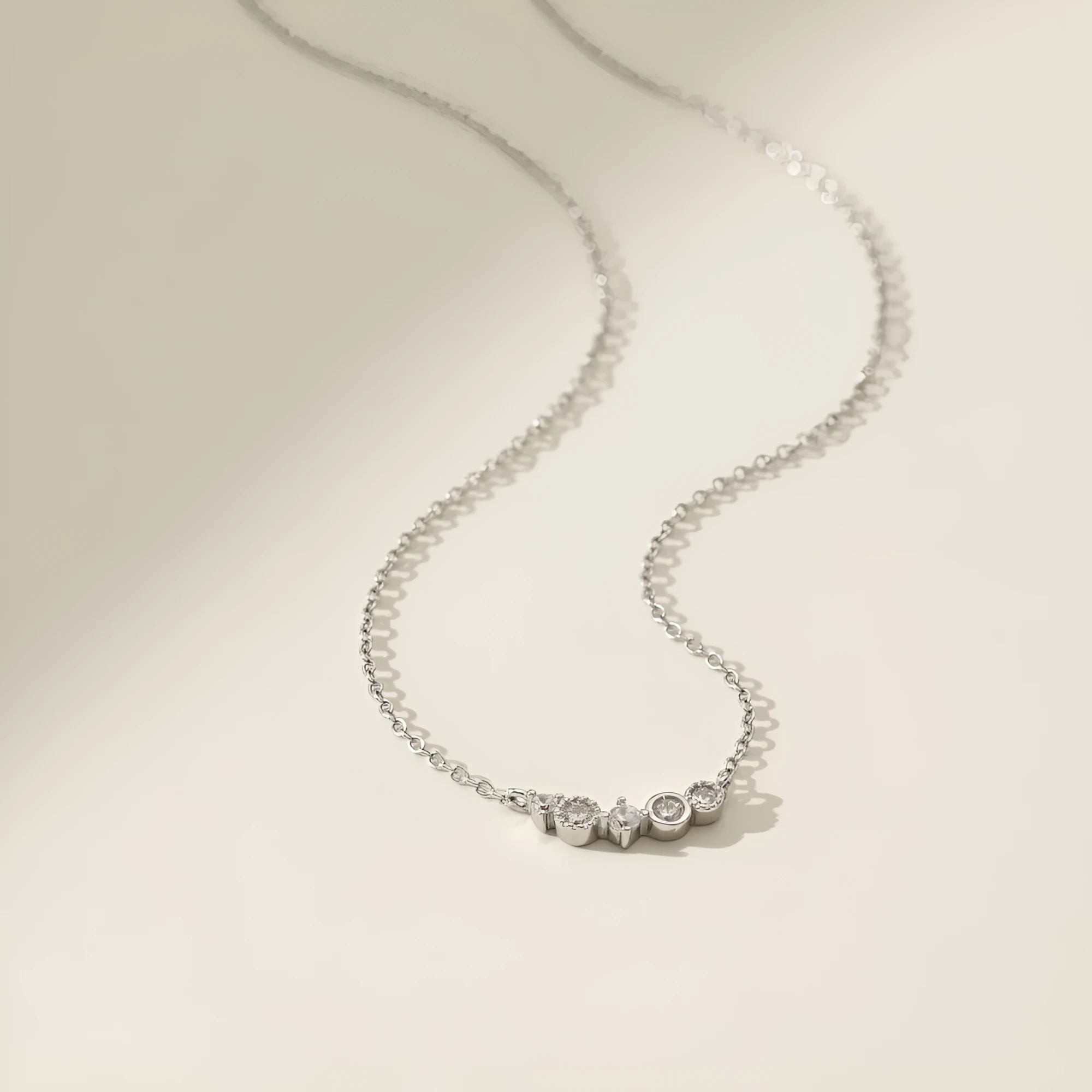 Geometric zircon pendant necklace in 925 silver with gold electroplate finish on display