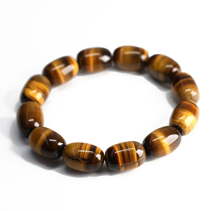 Yellow Tiger's Eye gemstone beaded bracelet with ethnic styling on a wrist.