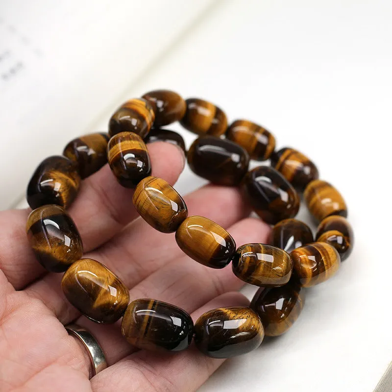 Yellow Tiger's Eye gemstone beaded bracelet with ethnic styling on a wrist.