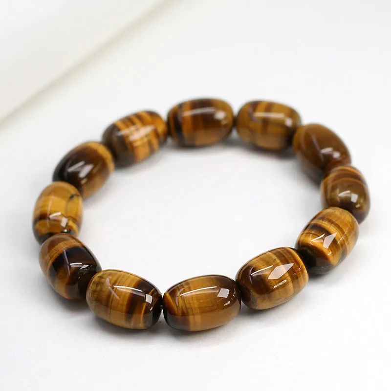Yellow Tiger's Eye gemstone beaded bracelet with ethnic styling on a wrist.