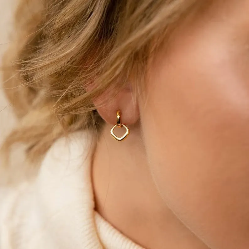 Double ring twist geometric square ear clip simple copper earrings on a neutral background
