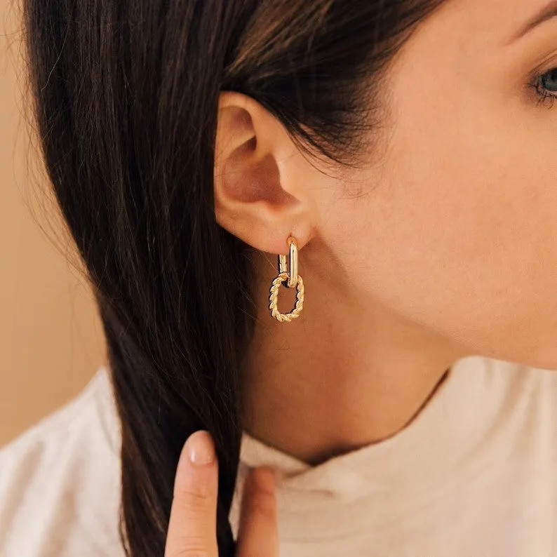 Double ring twist geometric square ear clip simple copper earrings on a neutral background
