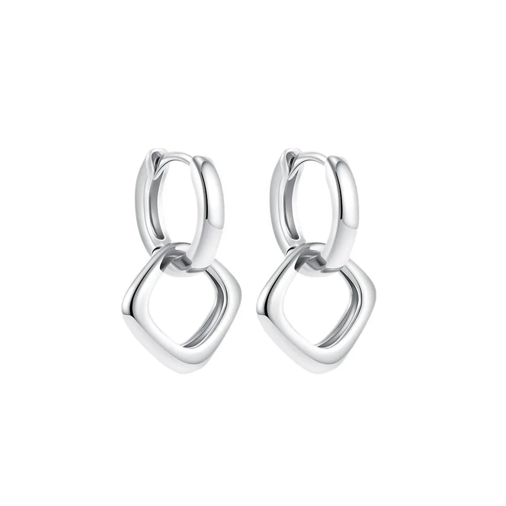 Double ring twist geometric square ear clip simple copper earrings on a neutral background
