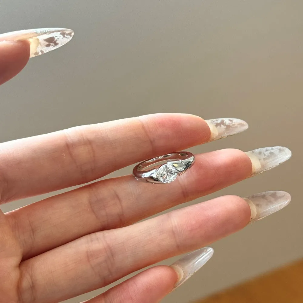 Silver round ring with glossy electroplated finish on display