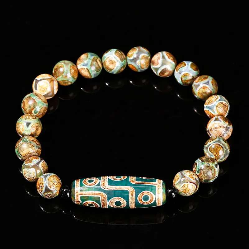 Handmade green dzi bead barrel bracelet with 8mm round geometric beads on a wrist.