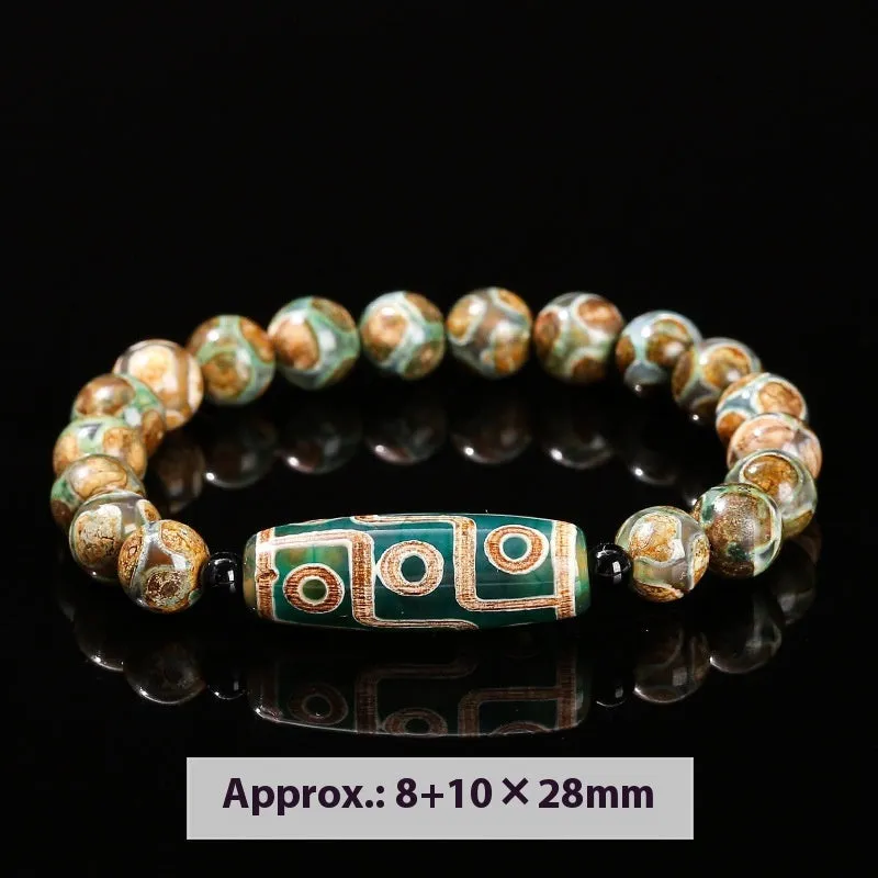 Handmade green dzi bead barrel bracelet with 8mm round geometric beads on a wrist.
