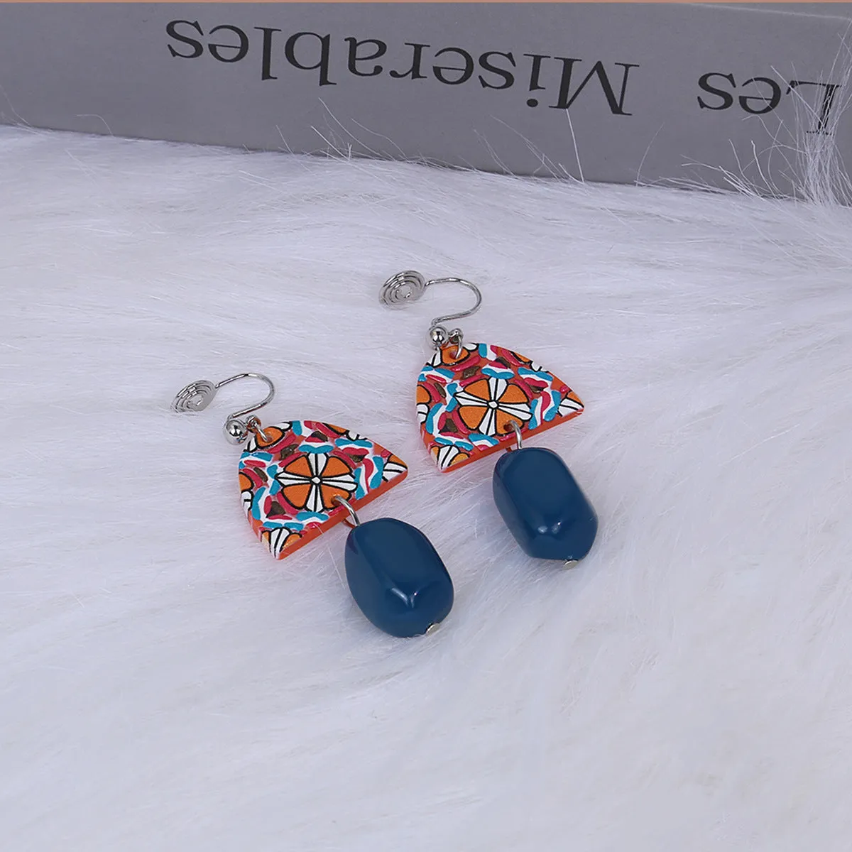 Retro yellow blue contrast acrylic earrings with irregular geometric shapes on white background.