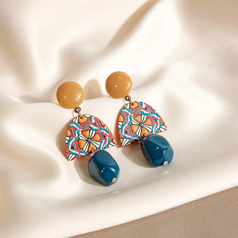 Retro yellow blue contrast acrylic earrings with irregular geometric shapes on white background.