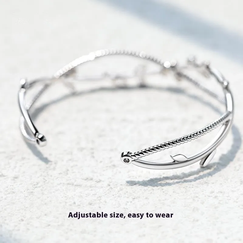 Cross twisted white gold electroplated bracelet with tree charm on copper base.