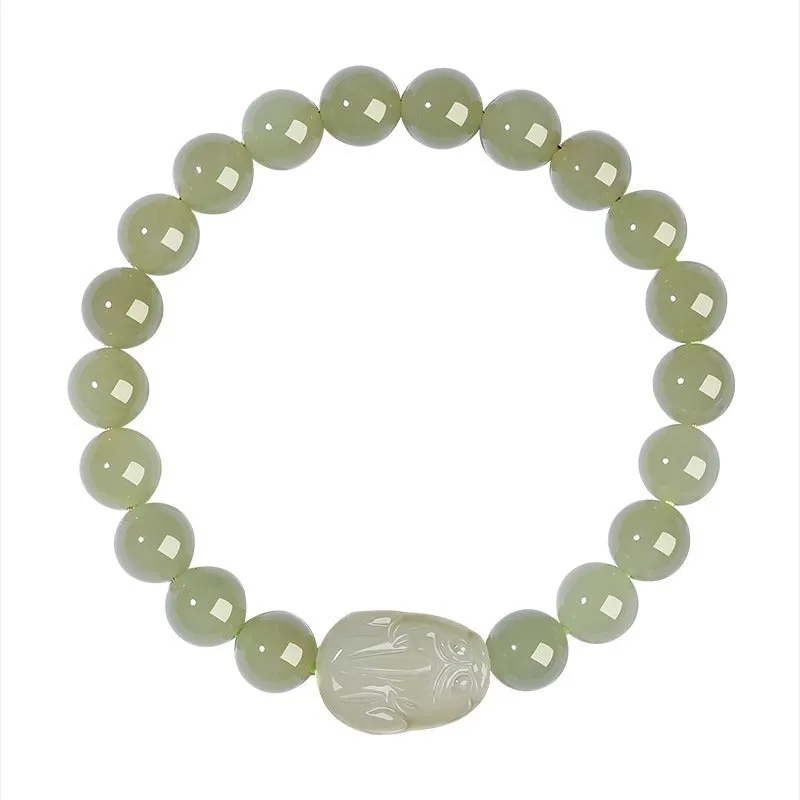 Grey Hetian jade ethnic style bracelet with polished beads on a wrist.