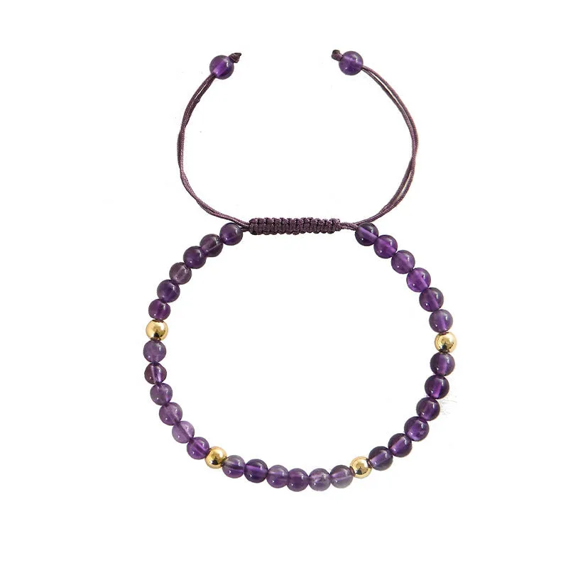 Handmade purple amethyst and 14K gold bracelet with 4mm round beads on a wrist.