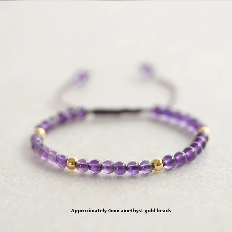 Handmade purple amethyst and 14K gold bracelet with 4mm round beads on a wrist.