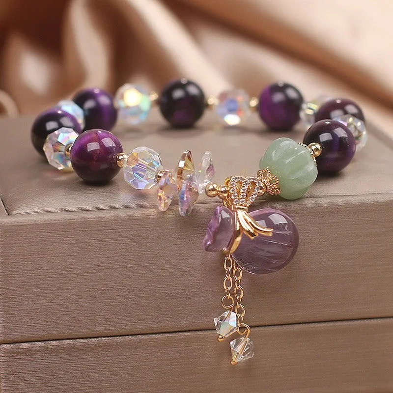 Women's forest style crystal bracelet with purple Tigereye money bag pendant and rhinestone details
