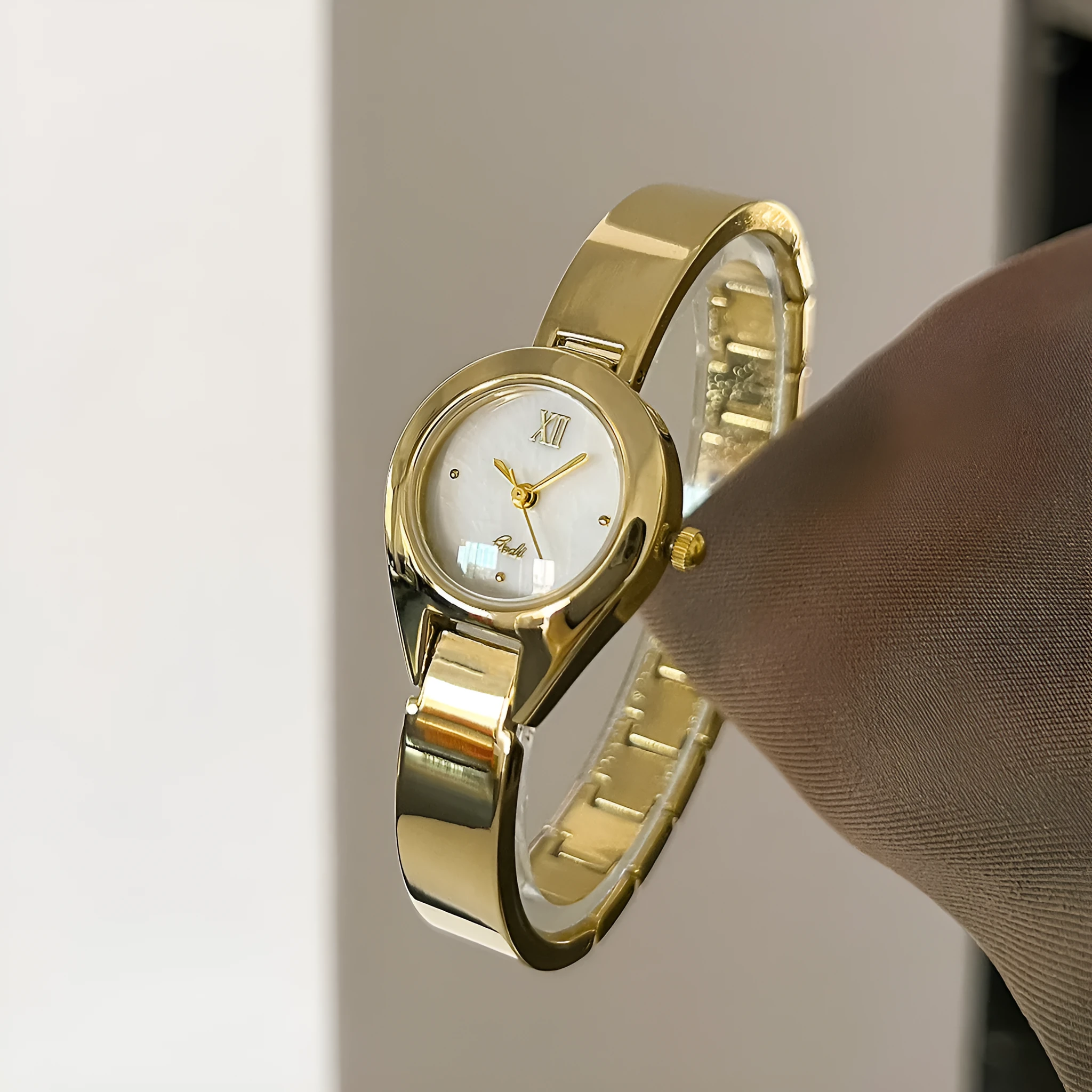 Women's quartz watch with 30mm white shell dial, silver hands, and white strap on display
