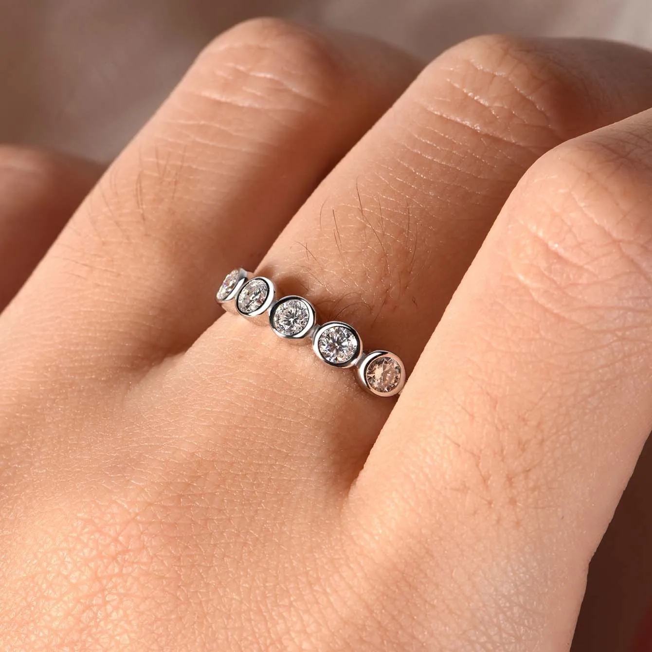 925 silver round moissanite ring with white gold electroplated finish on a geometric band, available in sizes 5 to 9