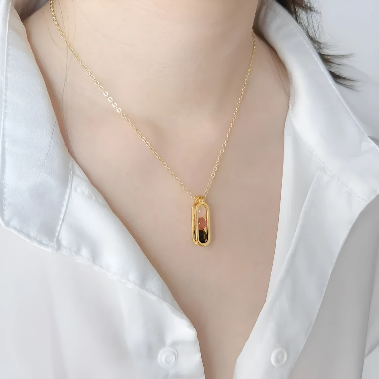 Minority simple pearl necklace with gold titanium steel chain and inlaid pearl pendant on plain background