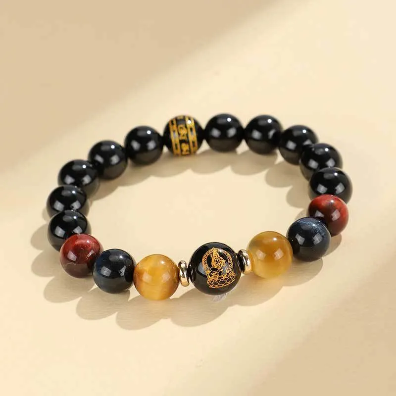 Manually crafted black agate beaded bracelet with gold, blue, and red tiger eye stones, showing ethnic zodiac design.