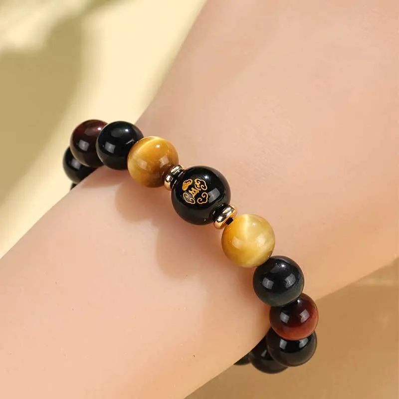 Manually crafted black agate beaded bracelet with gold, blue, and red tiger eye stones, showing ethnic zodiac design.