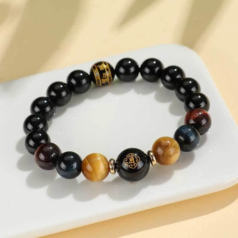 Manually crafted black agate beaded bracelet with gold, blue, and red tiger eye stones, showing ethnic zodiac design.