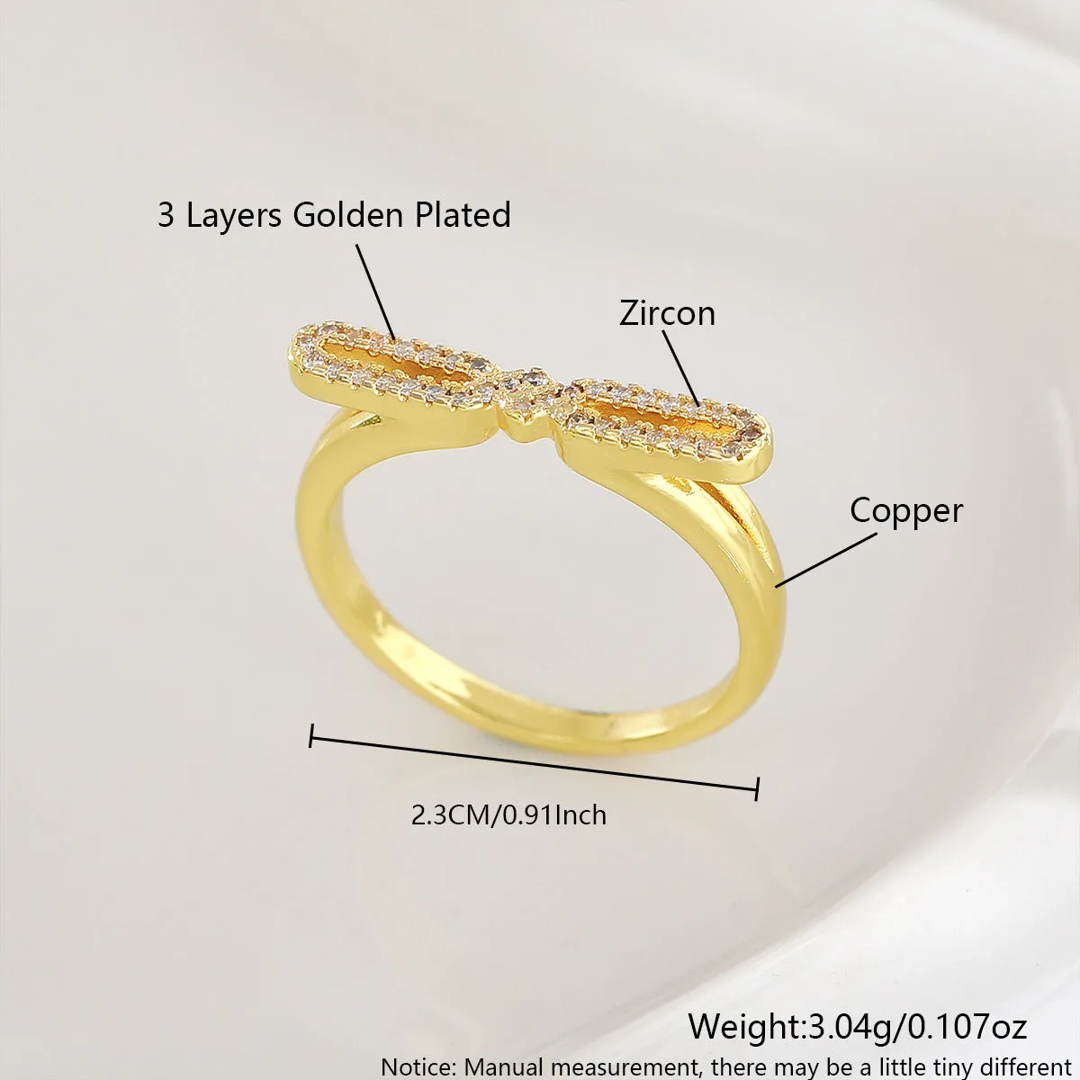 Fashion bowknot ring for women, copper with electroplated gold finish, bow shape on white background