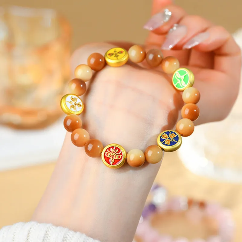 Yellow Bodhi seed bracelet showing five directions geometric design with round beads